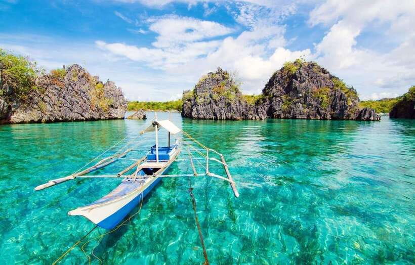Coron: Coastal Cliffs, Beach & Malcapuya Island Hopping Tour - Setting out from Coron by local banca